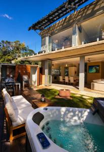 a house with a hot tub in the yard at Fishers Villa - Crescent Head in Crescent Head