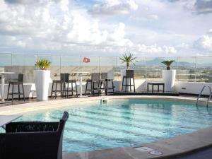 a swimming pool on the roof of a building at Novotel Tunis in Tunis