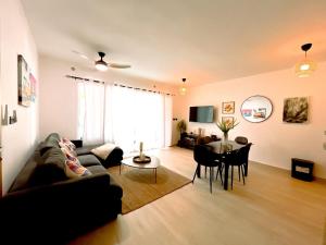 a living room with a couch and a table at Estrella Garden Condos con Vista a la piscina in San Rafael del Yuma