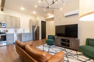 a living room with a couch and a large television at The Saint Clair in Frankfort