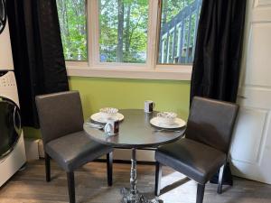 a table and two chairs and a table and a window at Sunset Suite in Bridgewater