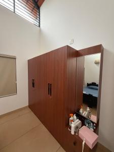 a room with a medicine cabinet with a mirror at Bodhi nila private villa in Irimbranallūr