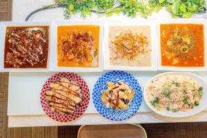 a table with four plates of different types of food at Kobe Sannomiya Union Hotel in Kobe +167 photos