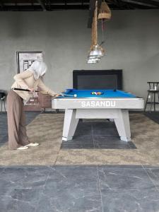 a person standing next to a pool table at Villa Sasandu Termanu in Gadog +23 photos