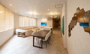 a living room with a couch and a table and chairs at Priyado Kochi in Kochi +18 photos
