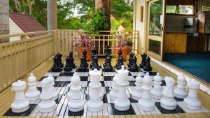 a chess board on a deck with a chessboard at Pacific Palms Resort in Charlotte Bay
