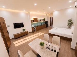 a hotel room with a bed and a table and chairs at Min Sweet Home 2 in Danang +7 photos