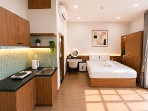 a hotel room with a bed and a sink at Min Sweet Home 2 in Danang