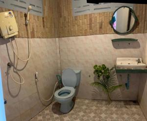 a bathroom with a toilet and a shower and a sink at Benny sweet family in Ao Phutsa
