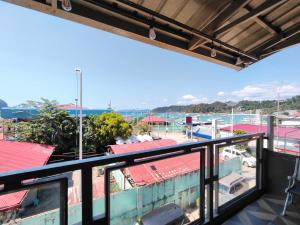a balcony with a view of a marina at Joaquinn's Bed and Breakfast El Nido City near Beach in El Nido