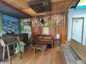 a room with a bench and a piano in it at Joaquinn's Bed and Breakfast El Nido City near Beach in El Nido