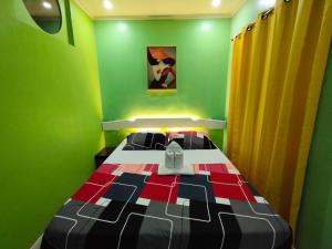 a bedroom with a bed in a green room at Joaquinn's Bed and Breakfast El Nido City near Beach in El Nido +39 photos