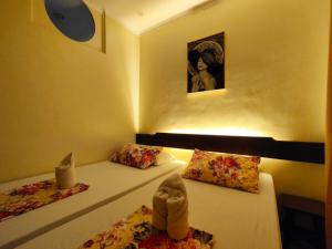 a room with two beds with a stuffed animal sitting on them at Joaquinn's Bed and Breakfast El Nido City near Beach in El Nido