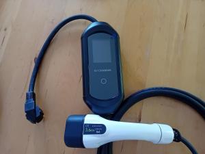 a cell phone hooked up to a charger at Villa des écureuils in Dole