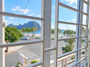 a view of a beach from a window at Sao Mai Hotel Hạ Long in Ha Long