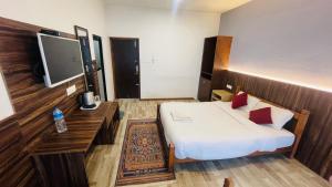 a hotel room with a bed and a flat screen tv at Hotel Dhulikhel View Point in Dhulikhel