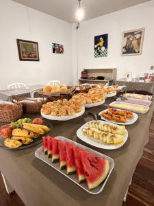 a table with a bunch of different types of food at Hotel Montanas in Nova Friburgo