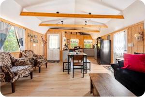 a living room with a table and a kitchen at Serenity Cabin - Cozy Mountain retreat near Shenandoah National Park in Luray