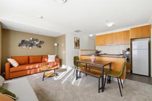 a living room with a couch and a table at Stylish 2-Bed Stay with Pool & Parking in Canberra
