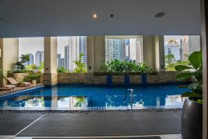 a large swimming pool in a building with a city at KL Tower Luxury Boutique Hotel Studio Fast WiFi Resort Swimming Pool Sauna & Gym in Manila