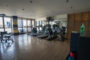 a gym with treadmills and ellipticals in a room at KL Tower Luxury Boutique Hotel Studio Fast WiFi Resort Swimming Pool Sauna & Gym in Manila