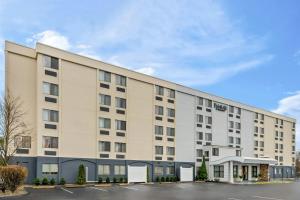 a large white building with a parking lot at Fairfield Inn Boston Woburn in Woburn