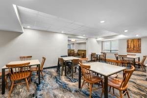 an empty dining room with tables and chairs at Fairfield Inn Boston Woburn in Woburn