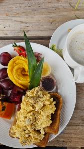 a plate of food with toast and a cup of coffee at Cataleya BDT in Bocas Town