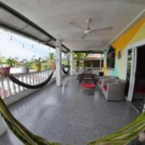 a room with a porch with a hammock on a balcony at Cataleya BDT in Bocas Town