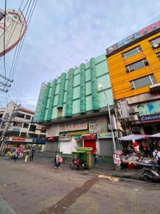 a group of buildings with people standing in front of them at Nice Hotel Arayat Cubao in Manila