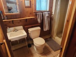 a small bathroom with a toilet and a sink at Pine Haven in Mercer +27 photos