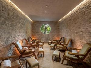 a room with chairs and a round window at Gdas Bali Health and Wellness Resort in Ubud +180 photos