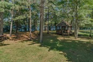 a gazebo in the middle of a park with trees at Pine Haven in Mercer