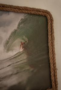 a painting of a person riding a wave on a surfboard at Vertical House Bali in Uluwatu