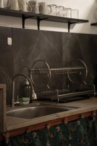 a kitchen sink with a metal drying rack above it at Vertical House Bali in Uluwatu +90 photos