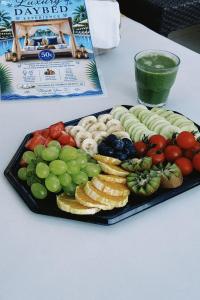 a tray of different types of fruit on a table at Beach Hotel Božikovina 2 in Podstrana +7 photos
