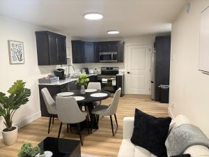 a kitchen and a living room with a table and chairs at Lovely Two-Bedroom APT at Kenmount Terrace in St. John's