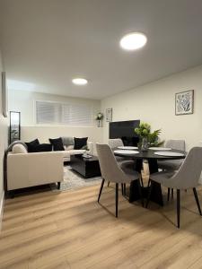 a living room with a couch and a table and chairs at Lovely Two-Bedroom APT at Kenmount Terrace in St. John's +10 photos