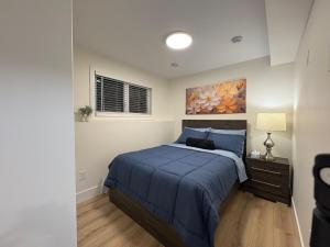 a bedroom with a bed and a painting on the wall at Lovely Two-Bedroom APT at Kenmount Terrace in St. John's