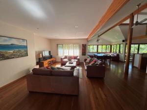 a living room with two couches and a television at Amaroo - Bring your own linen in Arakoon