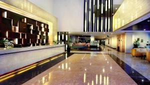 a lobby of a hotel with a large lobby at ASTON Bogor Hotel and Resort in Bogor