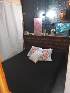 a bedroom with a bed with two pillows on it at Gather in Balneario Argentino