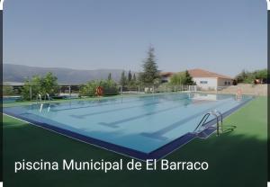 a large swimming pool with avationvationvationvationvationvationvationvationvationvation at Chalet Pinara in El Barraco