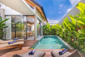 an indoor swimming pool in a villa at Ellavie Villa Ubud in Ubud