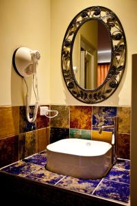 a bathroom with a sink and a mirror at Millennium Inn II in Kenting