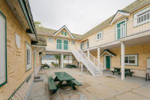 a patio of a building with a picnic table and stairs at Studio Suite 4 Green Gables Resort in Osoyoos