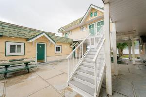 a stairway leading to a house with a green door at Studio Suite 4 Green Gables Resort in Osoyoos +40 photos