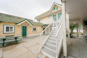 a stairway leading to a house with a green door at Studio Suite 8 Green Gables Resort in Osoyoos