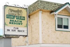 a sign for a beach resort on the side of a house at Studio Suite 7 at Green Gables Resort in Osoyoos