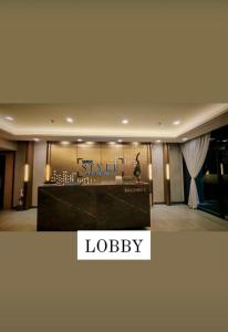 a woman standing in a lobby of a hotel at Mattys Crib Tower C Unit 204 in Iloilo City